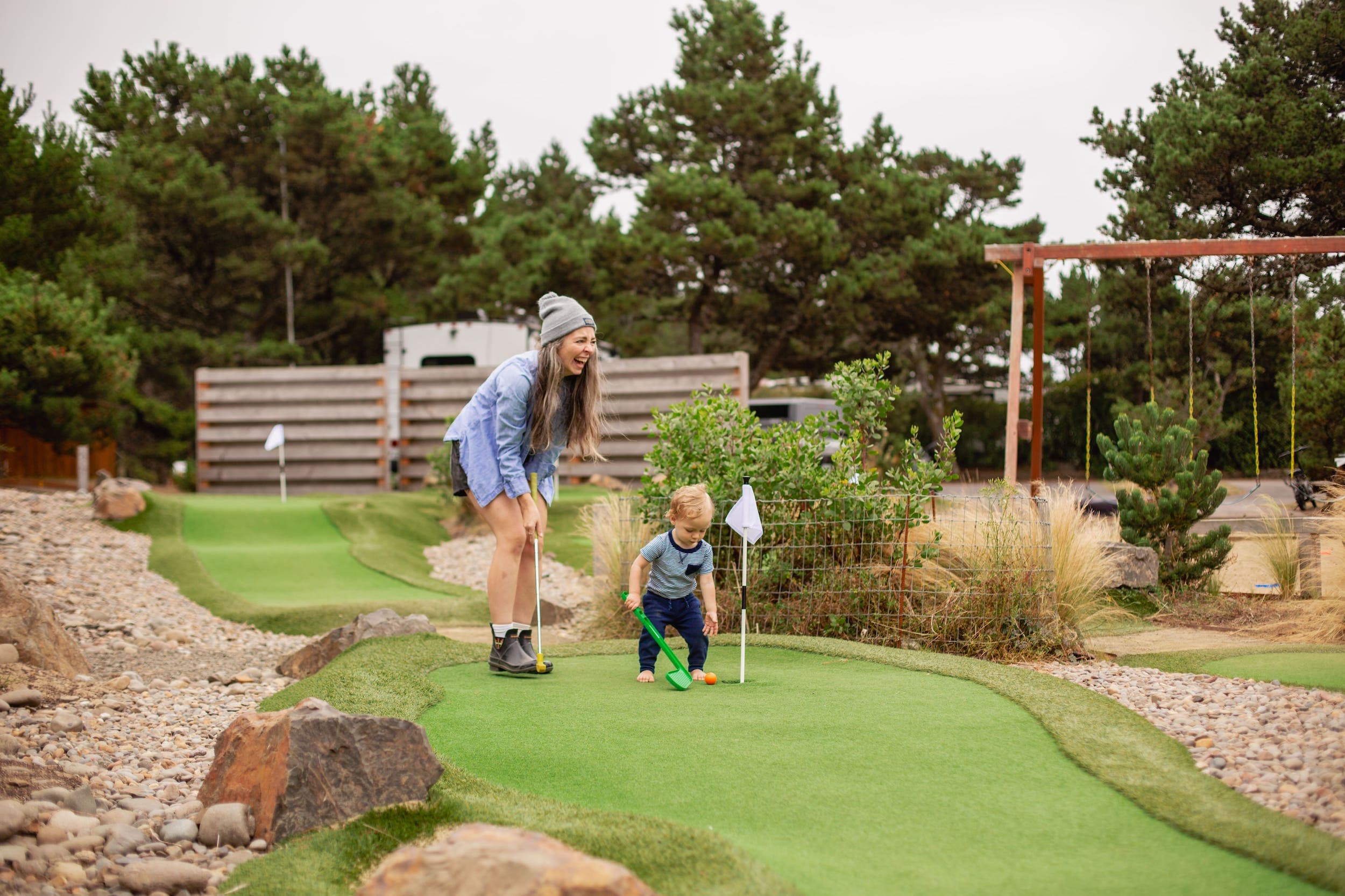 A mother and child playing mini putt at Inn at Cape Kiwanda