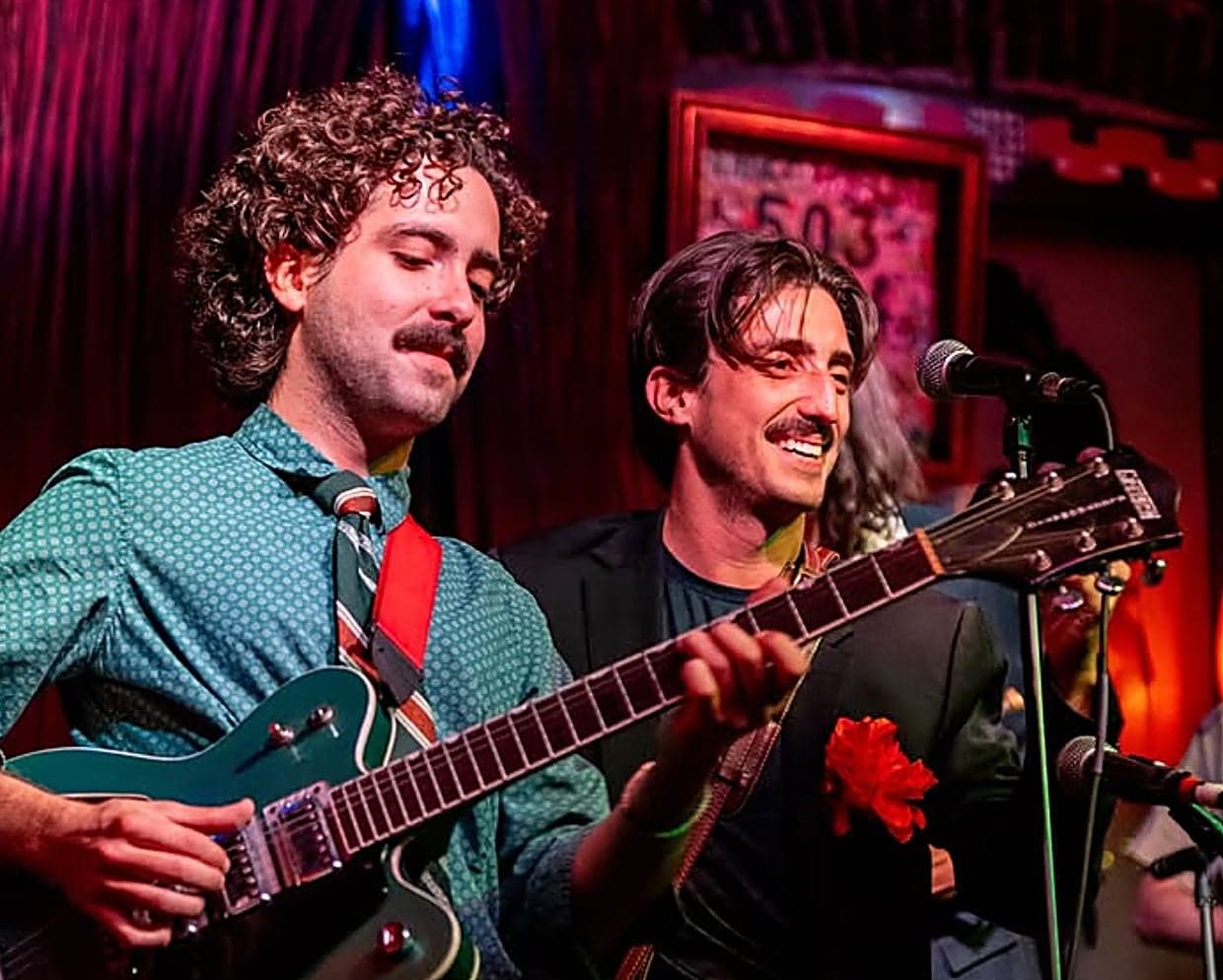 Live band performing at the Inn at Cape Kiwanda on the Oregon Coast, with two musicians playing guitar and singing during an evening concert in Pacific City