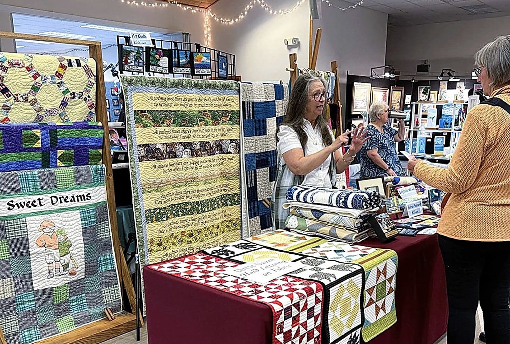 Handmade quilts on display with artist at Nestucca Valley Artisans art festival, Inn at Cape Kiwanda, Pacific City, Oregon Coast