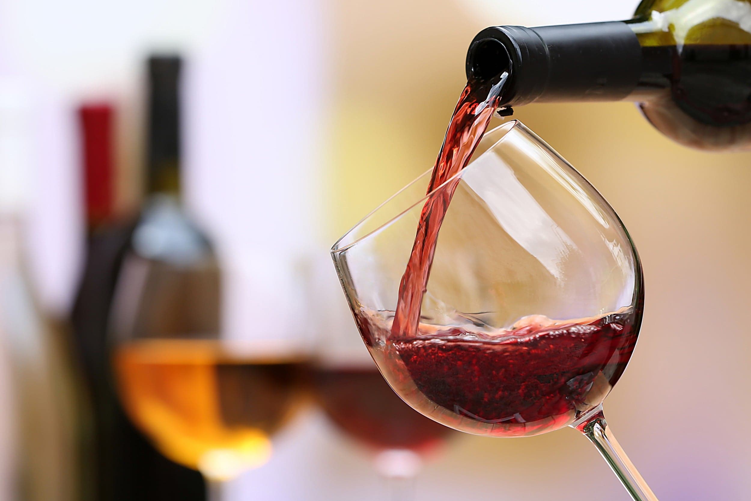 Red wine pouring into a glass at the Inn at Cape Kiwanda, Pacific City, Oregon Coast