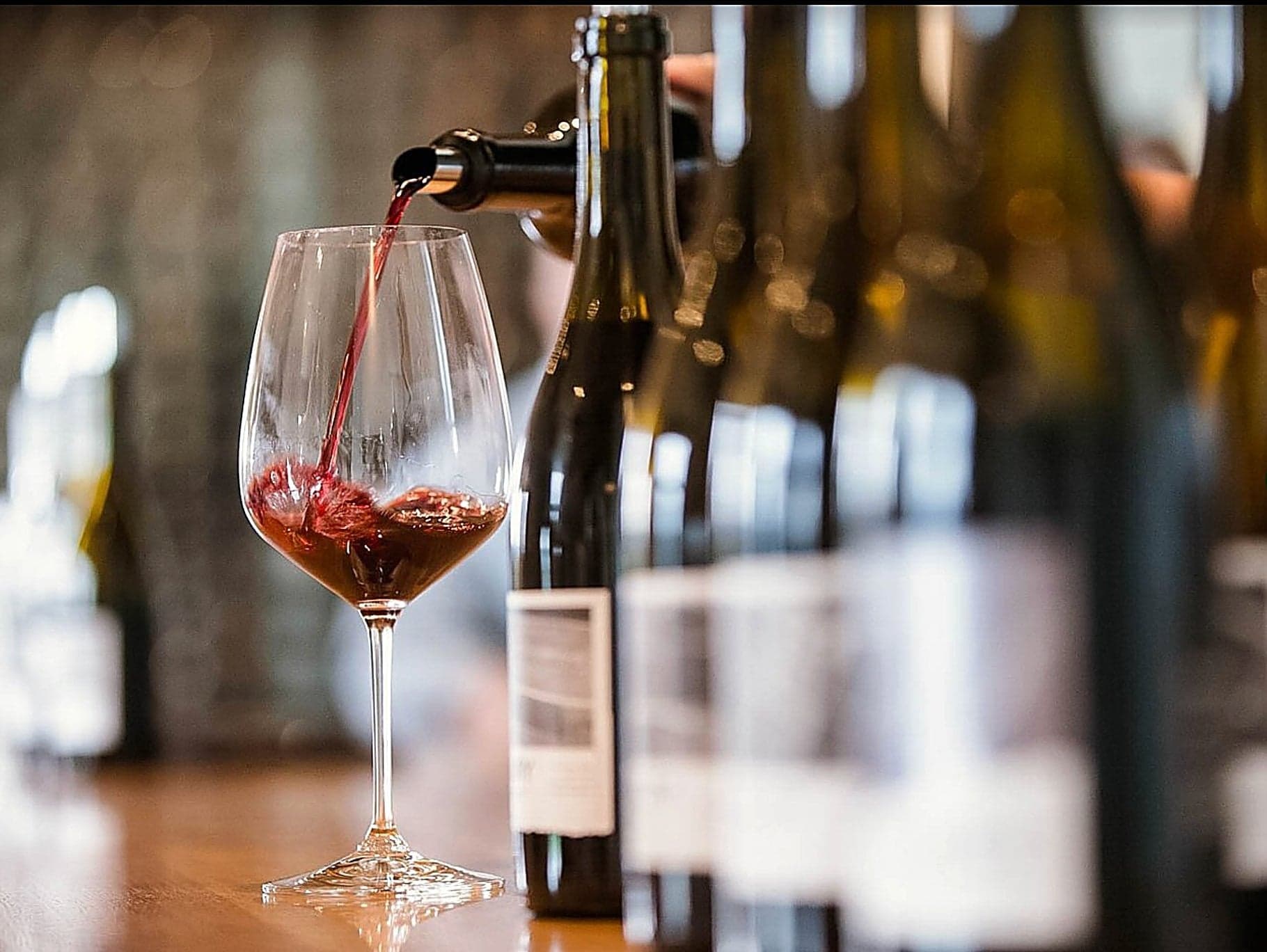 Red wine poured into a glass during a tasting at the Inn at Cape Kiwanda, Pacific City, Oregon Coast