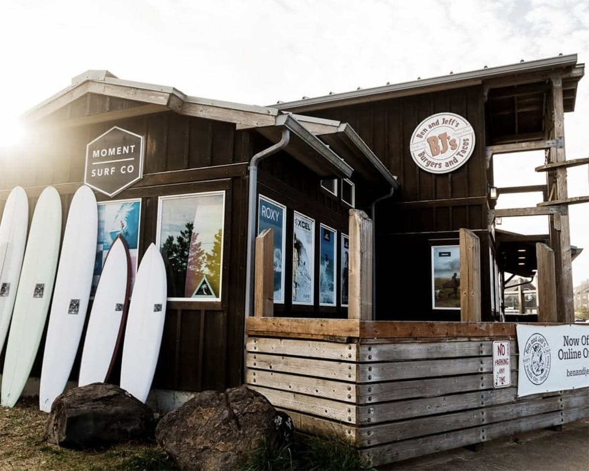 Surfboards lined up outside Moment Surf Co storefront near Cape Kiwanda, Inn at Cape Kiwanda, Pacific City, Oregon Coast