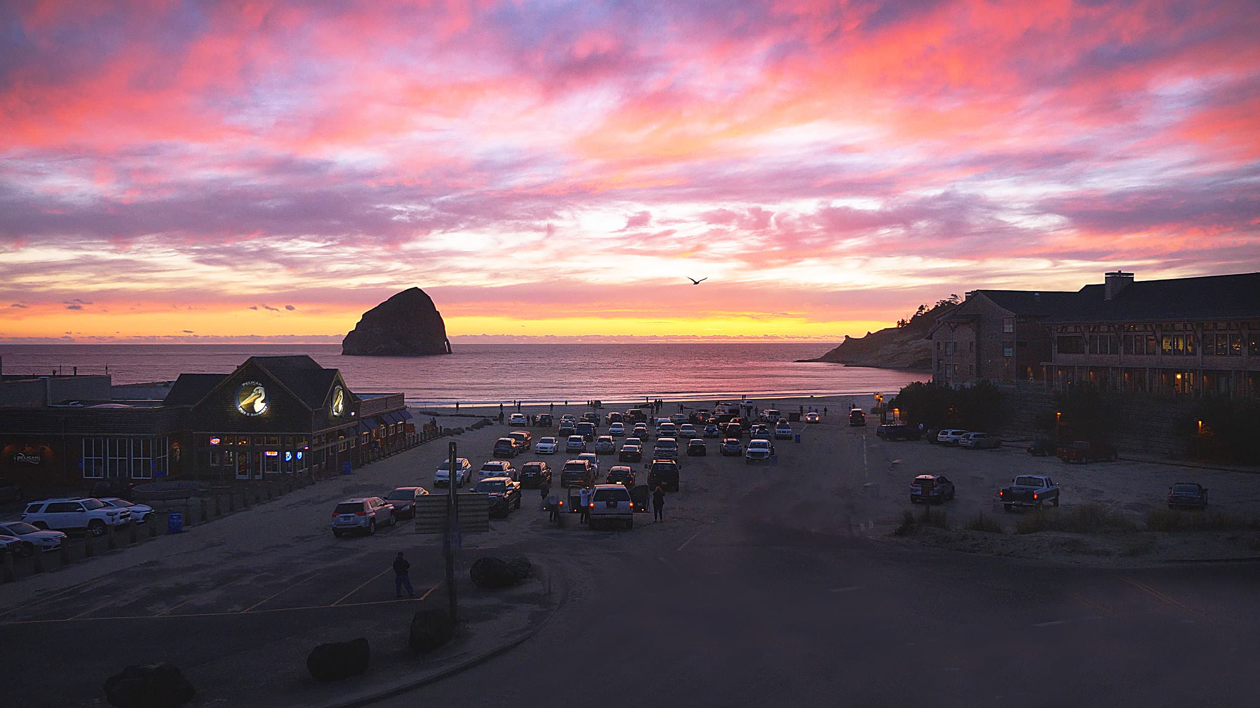 Pink sunset sky above the beach access at the Inn at Cape Kiwanda, Pacific City, Oregon