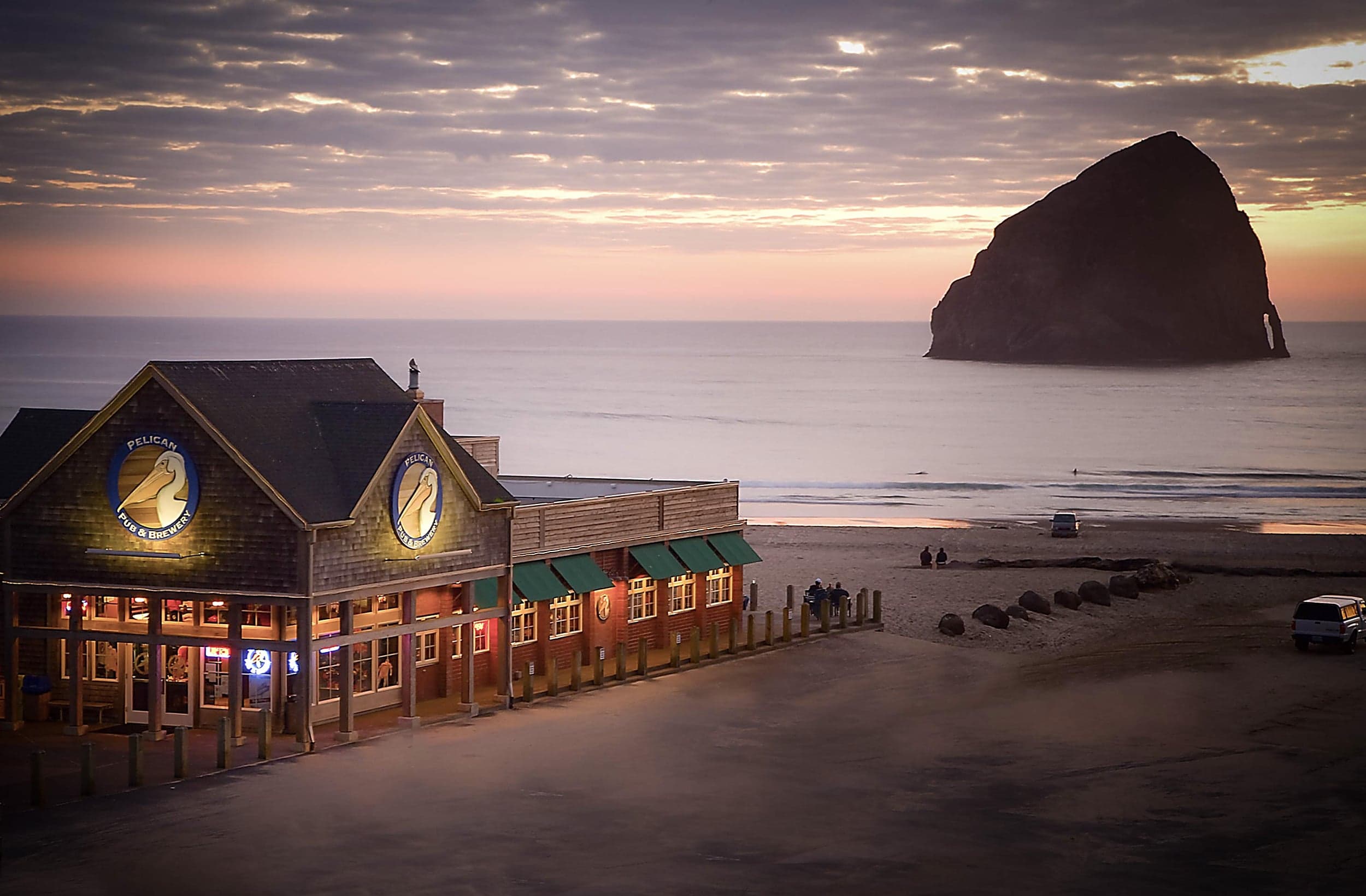 Pelican Pub & Brewery at sunset beside Cape Kiwanda's Haystack Rock, near the Inn at Cape Kiwanda, Pacific City, Oregon Coast