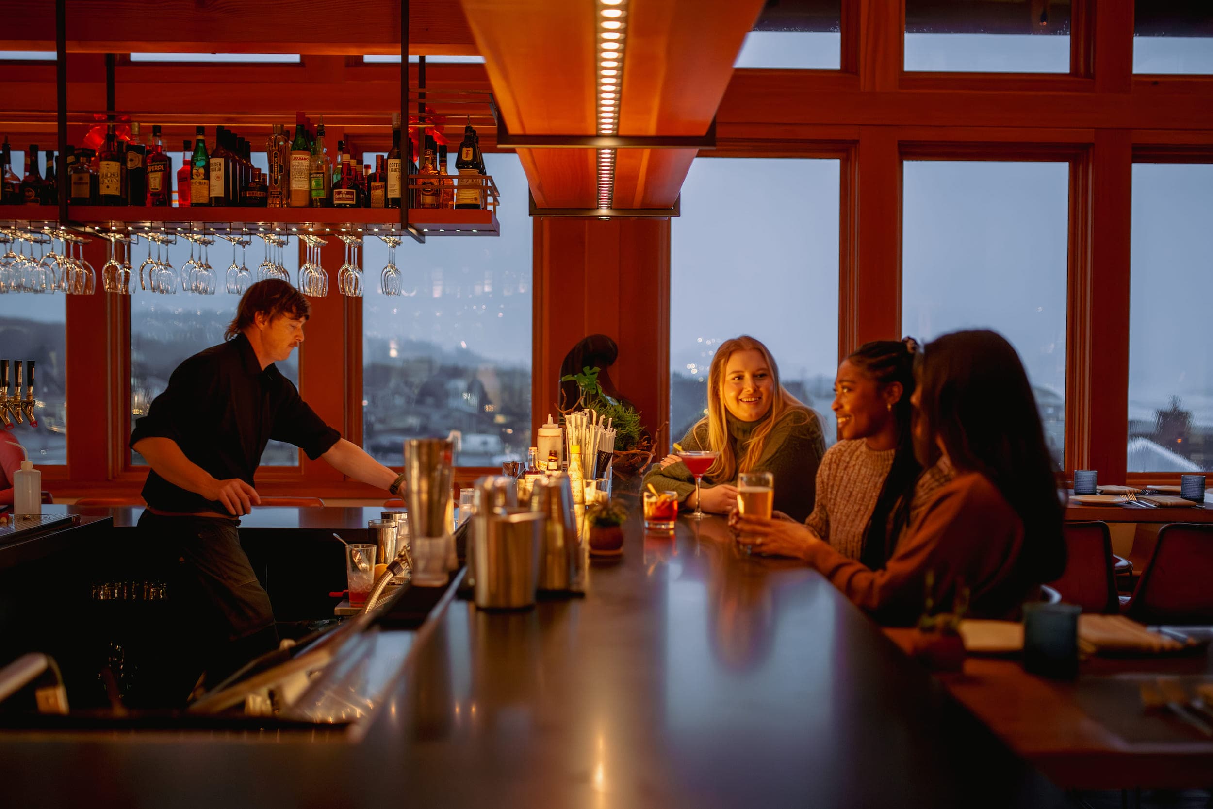 3 women sitting at the bar for Fireside Fridays
