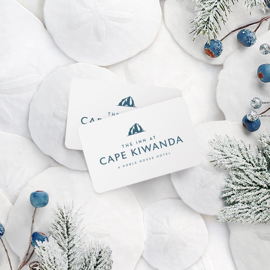 Two gift cards on a winter themed background for Inn at Cape Kiwanda