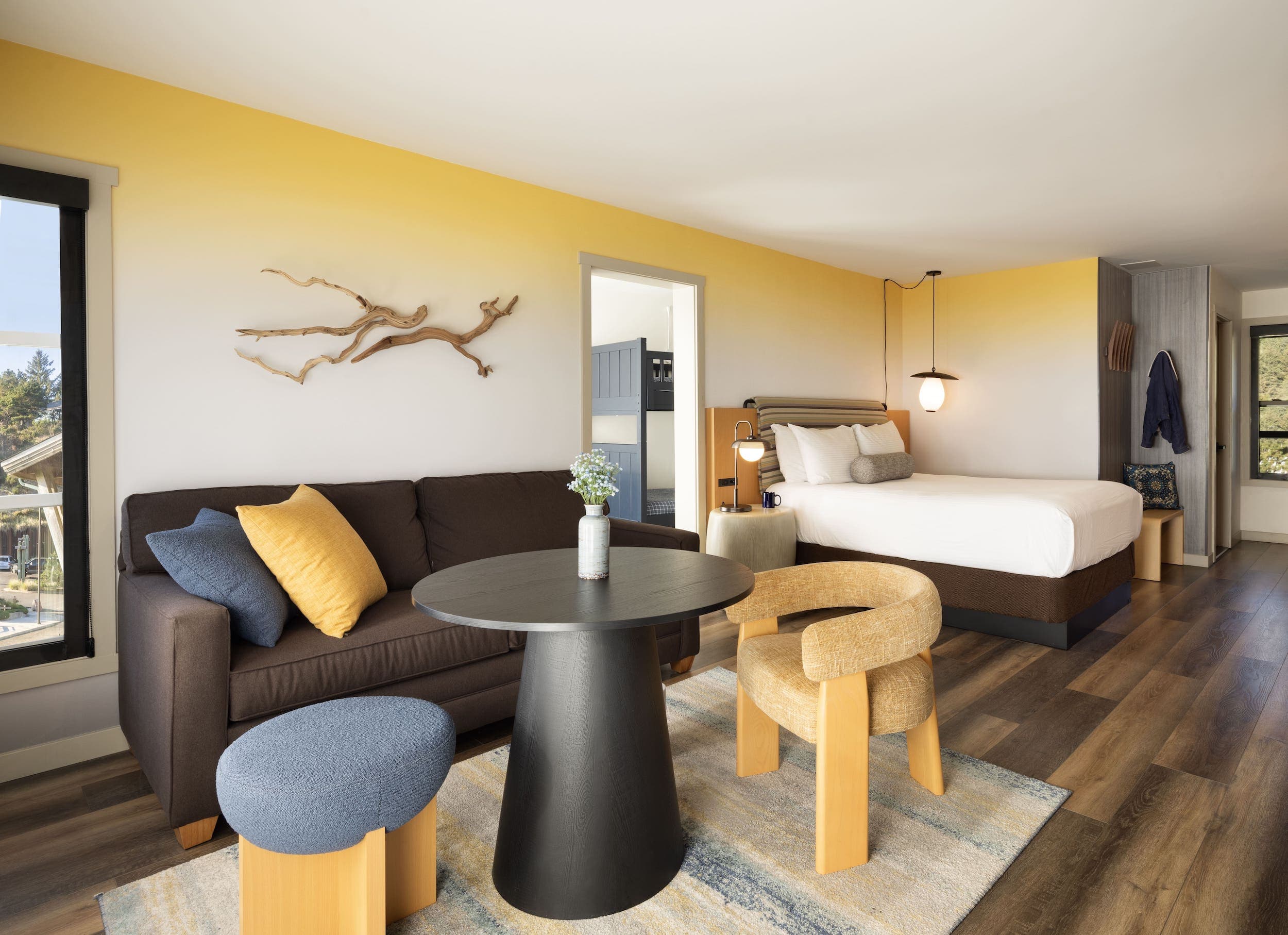 Inn At Cape Kiwanda Family Suite With Bunk and a living space with a round table and seating for two people