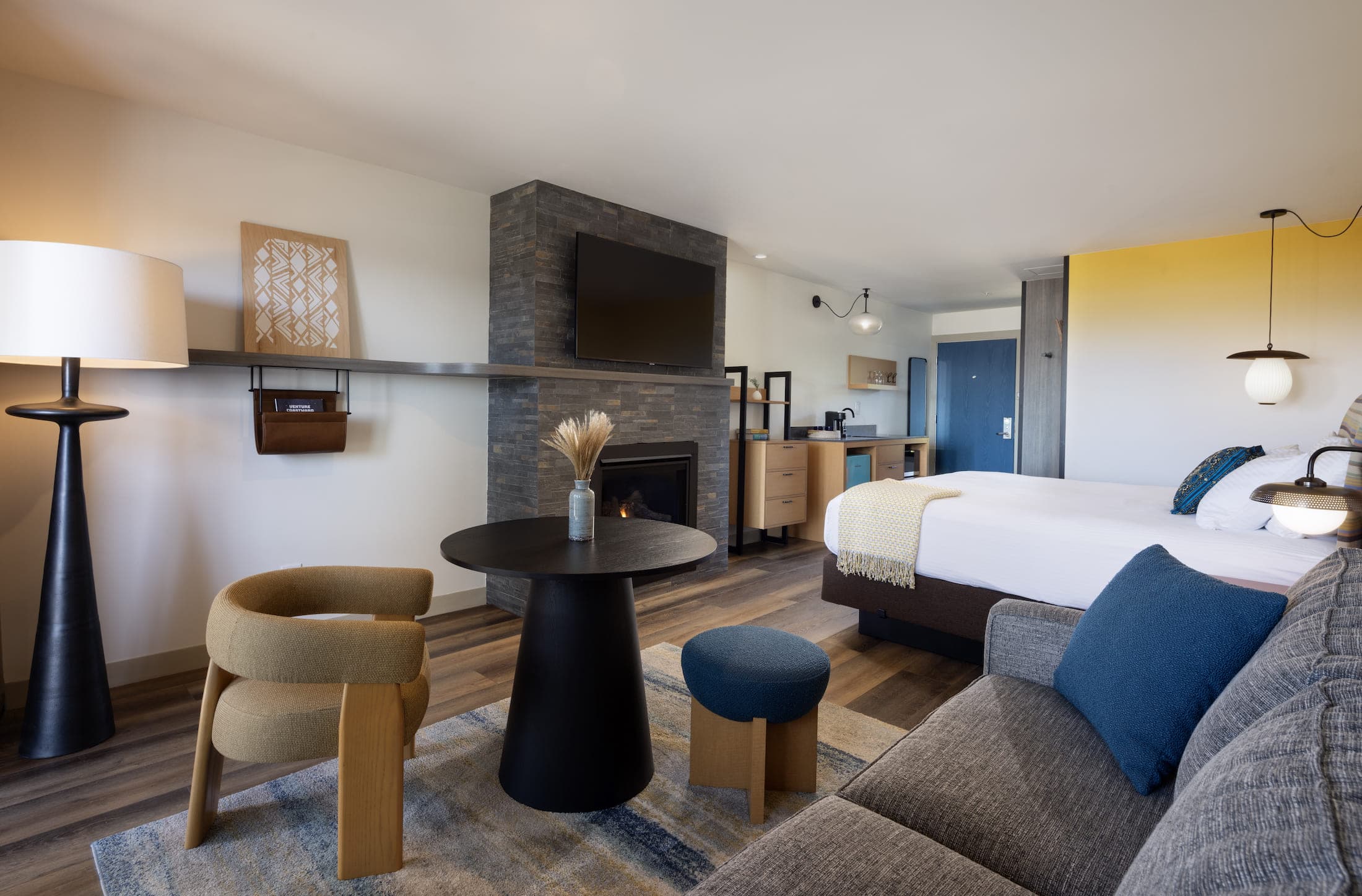 Inn At Cape Kiwanda Top Floor King open concept living space with bed and fireplace