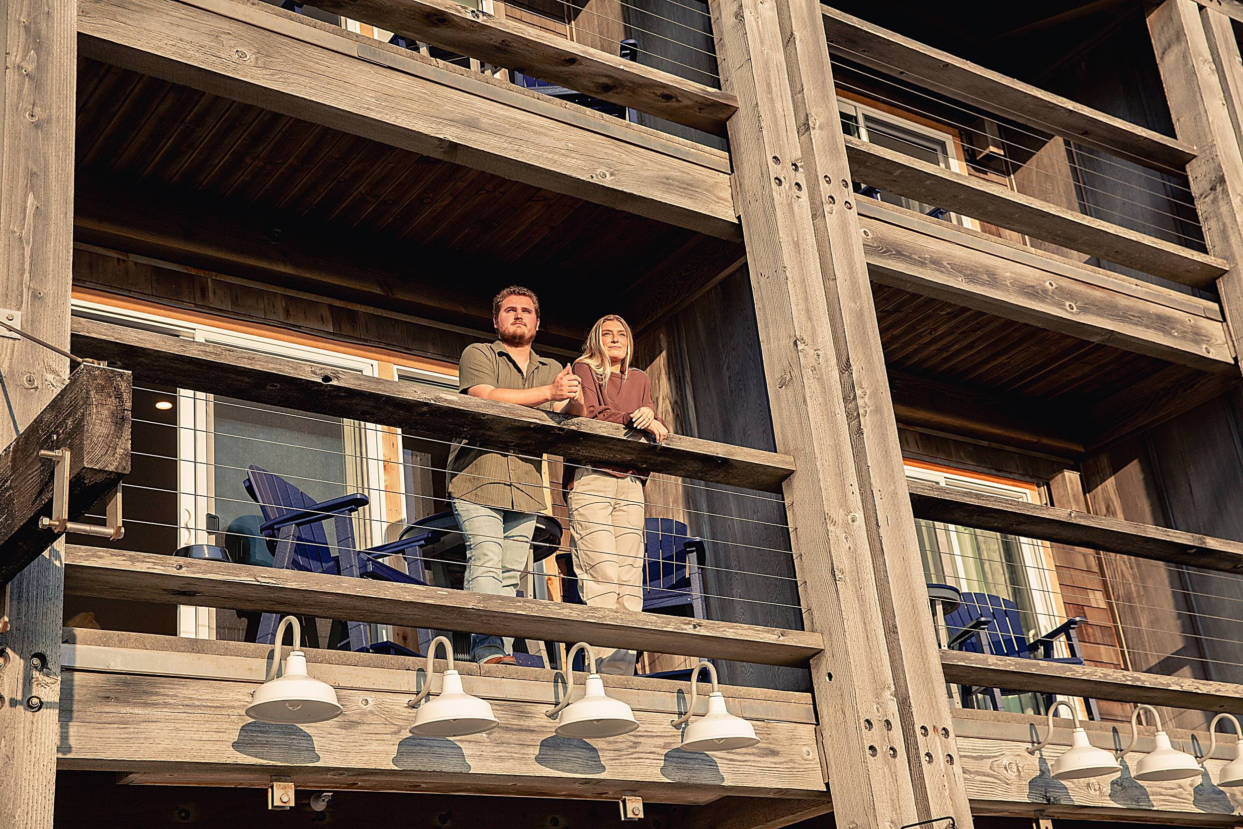 Couple on private balcony at the Inn at Cape Kiwanda, Pacific City, Oregon Coast