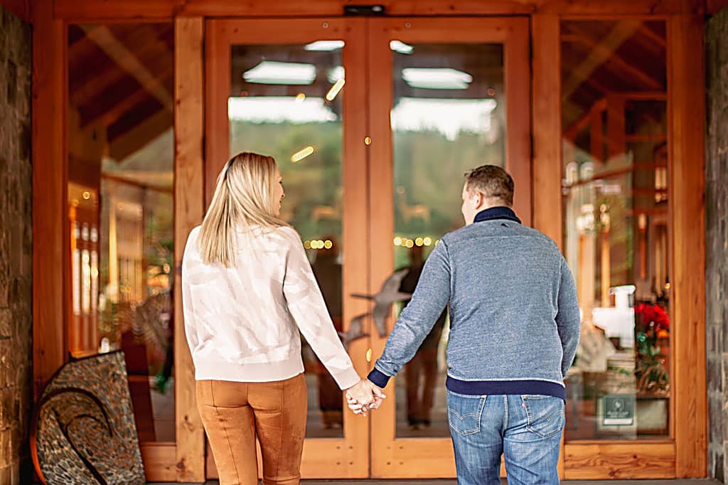 Couple holding hands entering the lodge at the Inn at Cape Kiwanda, Pacific City, Oregon Coast