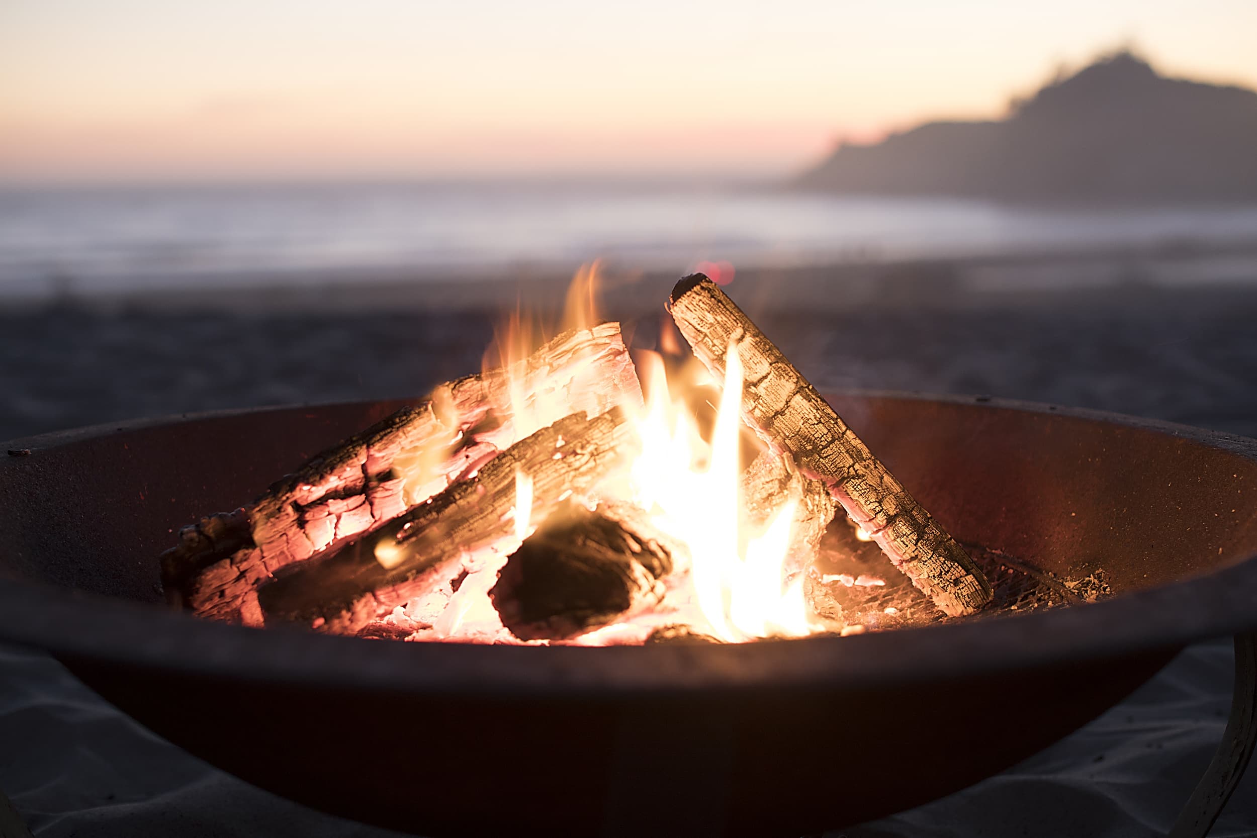 Glowing beach fire pit at dusk near the Inn at Cape Kiwanda, Pacific City, Oregon Coast