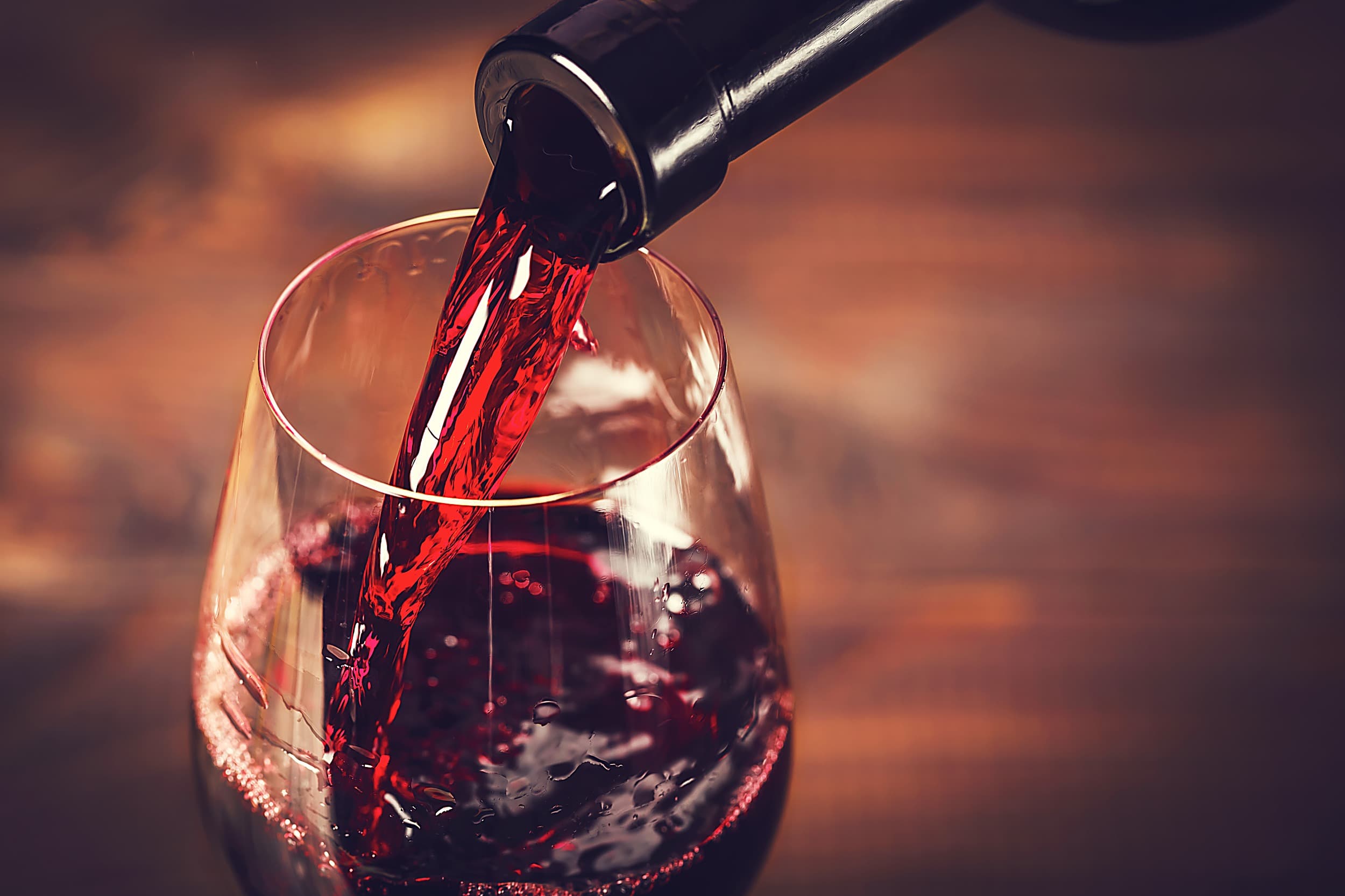 Red wine being poured into a glass at the Inn at Cape Kiwanda, Pacific City, Oregon Coast