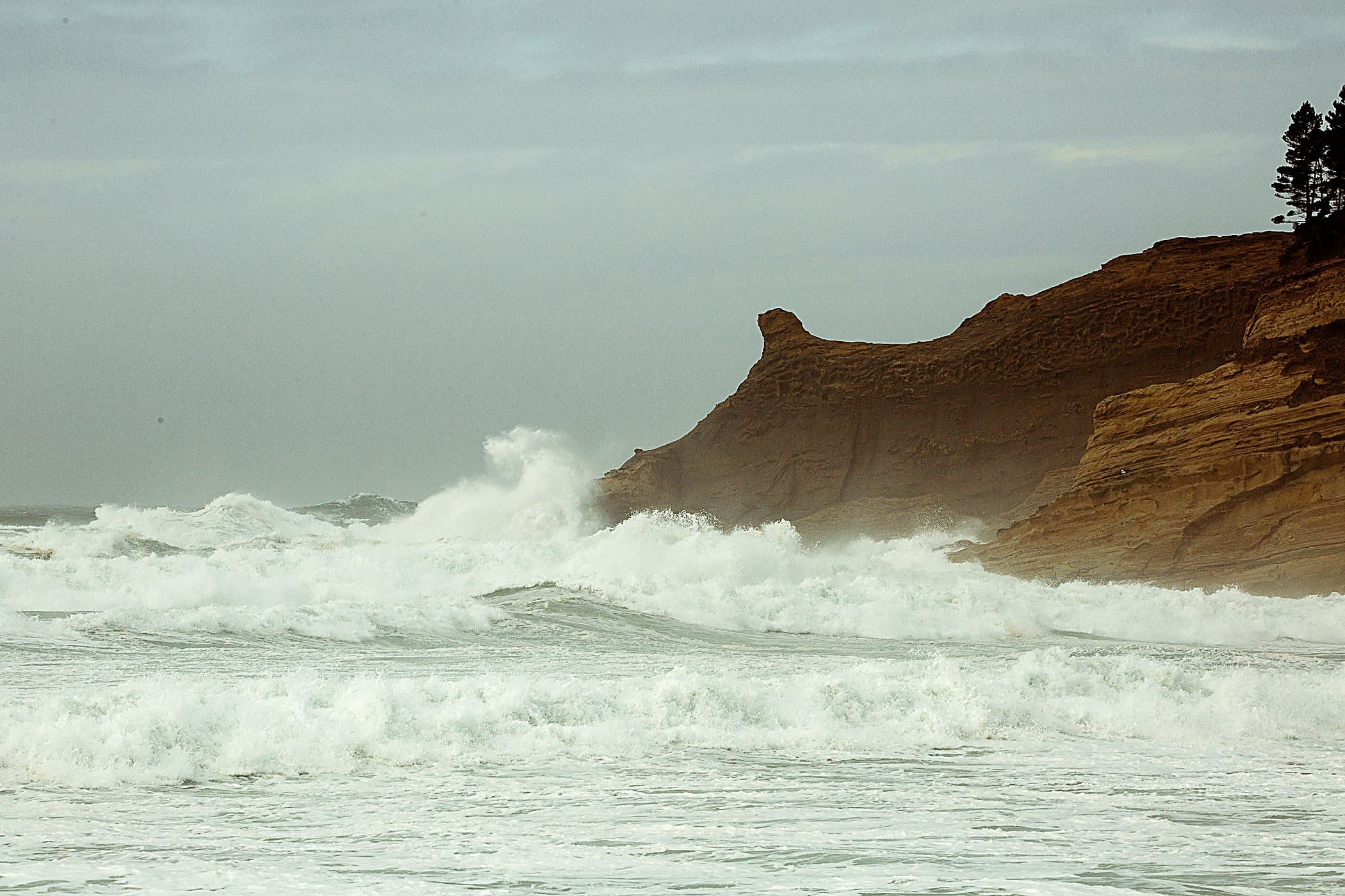Storm waves breaking below the Cape Kiwanda headland near the Inn at Cape Kiwanda, Pacific City, Oregon Coast
